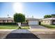 House exterior showcasing a single-car garage and manicured lawn at 10819 W Hatcher Rd, Sun City, AZ 85351