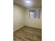 Simple bedroom with wood-look floors and window at 11411 N 91St Ave # 156, Peoria, AZ 85345