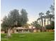 Community view showing green grass, pool, and palm trees at 11411 N 91St Ave # 156, Peoria, AZ 85345