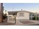 Mobile home exterior showcasing a covered carport and desert landscaping at 11411 N 91St Ave # 156, Peoria, AZ 85345