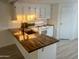 Remodeled kitchen with butcher block countertops and island at 11411 N 91St Ave # 156, Peoria, AZ 85345
