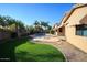 Relaxing backyard oasis with sparkling pool, fire pit, and grassy area at 12406 N 82Nd Ln, Peoria, AZ 85381