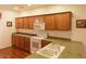 Kitchen with light wood cabinets and a double sink at 12406 N 82Nd Ln, Peoria, AZ 85381