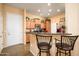 Kitchen with breakfast bar and view of entryway at 14575 W Mountain View Blvd # 11309, Surprise, AZ 85374