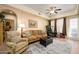 Living room with hardwood floors, comfy seating, and access to balcony at 14575 W Mountain View Blvd # 11309, Surprise, AZ 85374