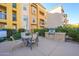 Outdoor seating area with a gas grill near the pool at 14575 W Mountain View Blvd # 11309, Surprise, AZ 85374