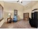 Relaxing Gathering room with recliner, shelving, and tile flooring at 14820 W Verde Ln, Goodyear, AZ 85395