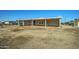 Tan house with covered porch and small yard at 18930 W Kaibab Rd, Buckeye, AZ 85326