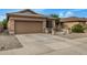 Single-story house with a two-car garage and well-maintained landscaping at 20874 E Sonoqui Dr, Queen Creek, AZ 85142