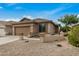 Single-story house with a two-car garage and nicely landscaped front yard at 20874 E Sonoqui Dr, Queen Creek, AZ 85142