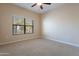 Well-lit bedroom featuring carpet, ceiling fan and window blinds at 21320 N 56Th St # 2175, Phoenix, AZ 85054