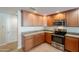Modern kitchen with wood cabinets and granite countertops at 21320 N 56Th St # 2175, Phoenix, AZ 85054