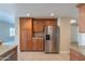 Stainless steel appliances and wood cabinets in kitchen at 21320 N 56Th St # 2175, Phoenix, AZ 85054