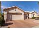 Two-car garage, light colored exterior, desert landscaping at 21906 N Dusty Trail Blvd, Sun City West, AZ 85375