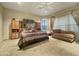 Large bedroom with a comfortable sitting area and large windows at 2311 N 103Rd Dr, Avondale, AZ 85392