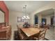 Bright dining room with a large wood table and chandelier at 2311 N 103Rd Dr, Avondale, AZ 85392