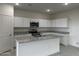 Modern kitchen with white cabinets, granite countertops, and island at 25353 N Selene Dr, Florence, AZ 85132