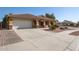 House exterior showcasing a large driveway and well-manicured lawn at 255 N 165Th Ave, Goodyear, AZ 85338