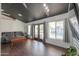 Living room with pool view, dark wood floors, and gray sofas at 2741 E Elmwood St, Mesa, AZ 85213