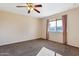 Well-lit bedroom featuring a window with curtains and ceiling fan at 3548 W Frier Dr, Phoenix, AZ 85051