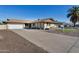 Ranch style home with a large driveway and mature landscaping at 3548 W Frier Dr, Phoenix, AZ 85051