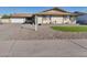 Single story home with a well-manicured lawn and driveway at 3548 W Frier Dr, Phoenix, AZ 85051