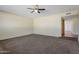 Spacious living room with neutral carpeting and ceiling fan at 3548 W Frier Dr, Phoenix, AZ 85051