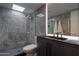 Modern bathroom with a glass shower, marble tile, and floating vanity at 4411 N 40Th St # 28, Phoenix, AZ 85018