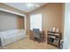 Small bedroom with a couch, desk, and built-in shelving at 5735 E Mcdowell Rd # 457, Mesa, AZ 85215