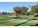 Community putting green with gazebo and palm trees at 5735 E Mcdowell Rd # 457, Mesa, AZ 85215