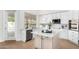 Modern kitchen with granite island, stainless steel appliances, and white cabinetry at 6442 E Winchcomb Dr, Scottsdale, AZ 85254