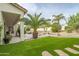 Landscaped backyard with a pool, artificial turf, and a patio at 730 E Mesquite St, Phoenix, AZ 85086