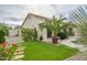 Landscaped backyard with a pool, artificial turf, and stone pathway at 730 E Mesquite St, Phoenix, AZ 85086