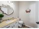 Elegant powder room with granite countertop and decorative mirror at 730 E Mesquite St, Phoenix, AZ 85086