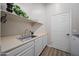 Bright laundry room with utility sink and ample storage at 730 E Mesquite St, Phoenix, AZ 85086