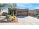 Single-story home with desert landscaping and a two-car garage at 9573 E Chuckwagon Ln, Scottsdale, AZ 85262