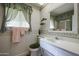 Neat bathroom with updated vanity and shower/tub combo at 10927 W Peoria Ave, Sun City, AZ 85351