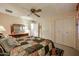 Bright bedroom featuring a ceiling fan and built-in closet at 10927 W Peoria Ave, Sun City, AZ 85351