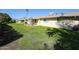 View of the back of the house with a grassy yard at 10927 W Peoria Ave, Sun City, AZ 85351