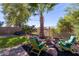 Landscaped backyard with fire pit and seating at 11163 E New Frontier Ct, Gold Canyon, AZ 85118