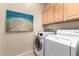 Laundry room with washer, dryer, and cabinets at 11163 E New Frontier Ct, Gold Canyon, AZ 85118