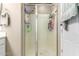 Shower with glass enclosure and built-in shelving at 14859 W Surrey Dr, Surprise, AZ 85379