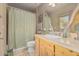 Bathroom with light wood vanity, shower, and decorative mirror at 16002 N Tabasco Cir, Fountain Hills, AZ 85268