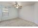 Simple bedroom with carpet, ceiling fan and window at 17867 W Eugene Ter, Surprise, AZ 85388