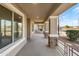 Long covered porch with stone columns, offering a relaxing outdoor space at 17867 W Eugene Ter, Surprise, AZ 85388