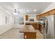 Kitchen with island and stainless steel refrigerator at 17867 W Eugene Ter, Surprise, AZ 85388