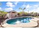 Relaxing freeform pool with a basketball hoop and patio furniture at 17867 W Eugene Ter, Surprise, AZ 85388