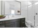 Modern bathroom with dark vanity, white tile, and shower at 19027 W Sierra St, Surprise, AZ 85388