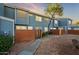 Two-story townhome with blue siding, brick wall, and walkway at 2301 E University Dr # 339, Mesa, AZ 85213