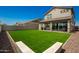 Large backyard with artificial turf and a view of the house's back elevation at 24077 N 160Th Ave, Surprise, AZ 85387